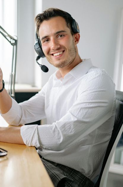 a man wearing a headphone and smiling